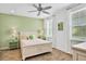 Bedroom with white bed frame and lime green accent wall at 3056 Parrot Head Pl, Kissimmee, FL 34747