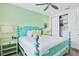 Bedroom with teal bed frame, light green walls and closet at 3056 Parrot Head Pl, Kissimmee, FL 34747