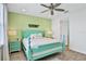 Bright bedroom with teal bed frame and ceiling fan at 3056 Parrot Head Pl, Kissimmee, FL 34747