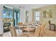Dining room with a large wooden table and access to the patio at 3056 Parrot Head Pl, Kissimmee, FL 34747