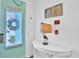 Inviting entryway with a teal door, decorative wreath, and a white accent table at 3056 Parrot Head Pl, Kissimmee, FL 34747