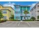 Two-story light blue house with teal accents and palm trees at 3056 Parrot Head Pl, Kissimmee, FL 34747