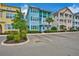 Two-story light blue house with teal accents and palm trees at 3056 Parrot Head Pl, Kissimmee, FL 34747