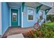 Bright teal house exterior with green door and two bicycles at 3056 Parrot Head Pl, Kissimmee, FL 34747