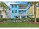 Two-story light blue house with private pool and lush lawn at 3056 Parrot Head Pl, Kissimmee, FL 34747