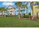 Two-story light blue house with private pool and lush lawn at 3056 Parrot Head Pl, Kissimmee, FL 34747