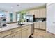 Island kitchen with stainless steel appliances and white cabinets at 3056 Parrot Head Pl, Kissimmee, FL 34747