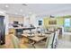Open concept kitchen with island, stainless steel appliances, and light cabinets at 3056 Parrot Head Pl, Kissimmee, FL 34747