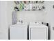 Laundry closet with washer, dryer and shelving at 3056 Parrot Head Pl, Kissimmee, FL 34747
