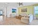 Bright living room featuring light sofas, a large TV, and wood-look tile at 3056 Parrot Head Pl, Kissimmee, FL 34747