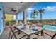 Covered patio with dining table and chairs overlooking the pool at 3056 Parrot Head Pl, Kissimmee, FL 34747