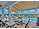 Outdoor patio dining area with table and chairs overlooking the pool at 3056 Parrot Head Pl, Kissimmee, FL 34747