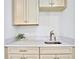 Wet bar with quartz countertop and cream cabinets at 3056 Parrot Head Pl, Kissimmee, FL 34747