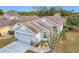 Gray house with a two-car garage and landscaping at 3965 Journey Ct, Casselberry, FL 32707