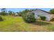 Large backyard with green grass and partial home view at 3965 Journey Ct, Casselberry, FL 32707