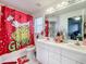 Bathroom with double vanity and Grinch-themed decor at 3965 Journey Ct, Casselberry, FL 32707