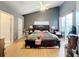 Main bedroom with wood floors and sliding glass door to patio at 3965 Journey Ct, Casselberry, FL 32707