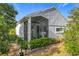 Rear view of house, showcasing the screened porch and landscaping at 3965 Journey Ct, Casselberry, FL 32707