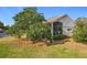 Side view of house with mature tree and screened porch at 3965 Journey Ct, Casselberry, FL 32707