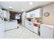 White kitchen features a center island and stainless steel sink at 3965 Journey Ct, Casselberry, FL 32707