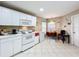 Kitchen with white cabinets, stove, microwave and refrigerator at 3965 Journey Ct, Casselberry, FL 32707