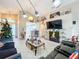 Open living room with tile flooring, a fireplace and views into kitchen at 3965 Journey Ct, Casselberry, FL 32707