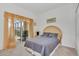 Bedroom with a queen bed and access to a screened patio at 4783 Cumbrian Lakes Dr, Kissimmee, FL 34746
