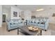 Living area with two sofas and a coffee table, open to the kitchen at 4783 Cumbrian Lakes Dr, Kissimmee, FL 34746