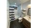 Modern bathroom with tub/shower, vanity, and striped shower curtain at 8711 Rockingham Ter # D, Kissimmee, FL 34747