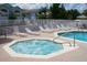 Community pool and hot tub area with lounge chairs at 8711 Rockingham Ter # D, Kissimmee, FL 34747