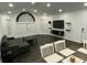 Living room with dark wood-look floors, gray sectional sofa, and dining table at 8711 Rockingham Ter # D, Kissimmee, FL 34747