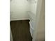 Empty walk-in closet with wire shelving and dark wood-look flooring at 8711 Rockingham Ter # D, Kissimmee, FL 34747