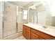 Main bathroom featuring tiled floors, shower stall, and double vanity at 1027 Royal Oaks Dr, Apopka, FL 32703