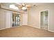 Large main bedroom with carpeted floors, ceiling fan, and ensuite bathroom access at 1027 Royal Oaks Dr, Apopka, FL 32703