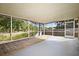 Screened-in porch with wooden deck and pond view at 1027 Royal Oaks Dr, Apopka, FL 32703