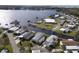 Aerial view of waterfront community with homes, canal, and lake at 115 Palm Dr, Eustis, FL 32726