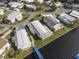 Aerial view of waterfront home near a community with a blue bridge at 115 Palm Dr, Eustis, FL 32726