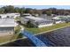 Aerial view of waterfront home with private dock and bridge access at 115 Palm Dr, Eustis, FL 32726