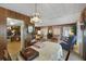 Open dining room with chandelier and access to living room at 115 Palm Dr, Eustis, FL 32726