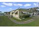 Mobile home with damaged awning and landscaping at 115 Palm Dr, Eustis, FL 32726