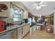 Eat-in kitchen features wood flooring and views into adjacent living space at 115 Palm Dr, Eustis, FL 32726