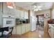 White kitchen cabinets, appliances, and wood flooring at 115 Palm Dr, Eustis, FL 32726