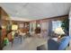 Living room with wood paneling and plenty of natural light at 115 Palm Dr, Eustis, FL 32726