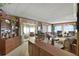 Spacious living room with wood paneling and ample seating at 115 Palm Dr, Eustis, FL 32726