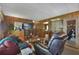 Spacious living room with wood paneling and view of kitchen at 115 Palm Dr, Eustis, FL 32726