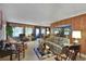 Living room features wood paneling, comfy seating, and a wood coffee table at 115 Palm Dr, Eustis, FL 32726