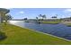 Beautiful view of the canal and lush green grass at 115 Palm Dr, Eustis, FL 32726