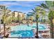 Resort-style pool with lounge chairs and palm trees at 12521 Floridays Resort Dr # 207F, Orlando, FL 32821