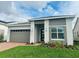 Modern one-story home with attached garage and landscaped front yard at 2817 Willowseed Ln, St Cloud, FL 34772