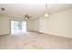 Living room with carpeted floors, sliding glass doors, and a ceiling fan at 3054 George Mason Ave # 6, Winter Park, FL 32792